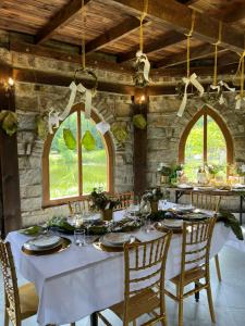 a dining room with a white table and chairs at Ironland Roztocze in Ruda Żelazna