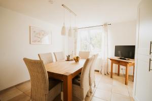 a dining room with a wooden table and chairs at MaTi´s Appartment 