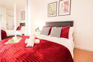 a bedroom with a red and white bed with a red blanket at Steps to Oxford Street-Central 1BR Flat Sleeps 4 in London