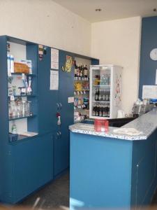 a blue kitchen with a counter and a refrigerator at Ubytovna u hospůdky in Ostrava