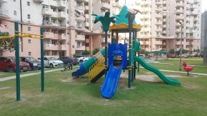 a playground with a slide in a park at 2BHK 65TV,FullyAC,family,Unmarried Couple,WFO Friendly peacefull place in Noida
