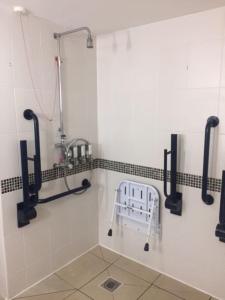 a shower stall in a bathroom with a sink at Hampton by Hilton Birmingham Broad Street in Birmingham