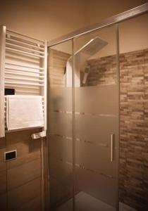 a shower with a glass door in a bathroom at 450mt to Basilica S.Pietro in Rome