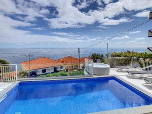 a swimming pool on the balcony of a house at Casa das Flores by LovelyStay in Calheta
