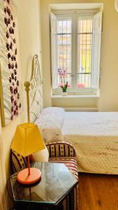 a bedroom with a bed and a table with a lamp at Lily CA in Cagliari