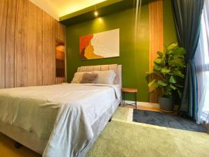 a bedroom with a bed and a green wall at Sentral Suites By RKD HOME in Kuala Lumpur