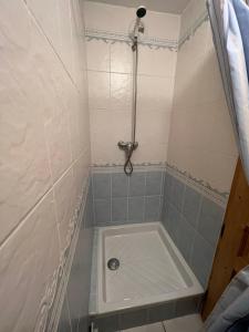 a small bathroom with a shower with a tub at Les Granges 13 6-8 person in Aime-La Plagne