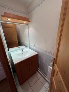 a bathroom with a sink and a mirror at Les Granges 13 6-8 person in Aime-La Plagne