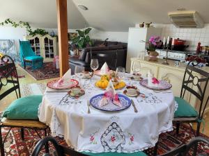 a dining room table with a white table cloth at Zorab&b in Breganzona +15 photos