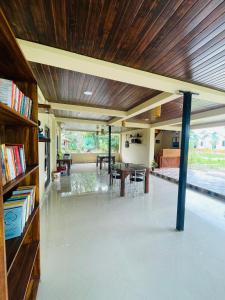 a living room with a wooden ceiling and a table at Daosri The Inn in Jyoti Gaon