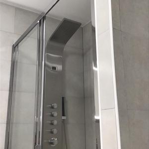 a shower with a glass door in a bathroom at Suite avec 2 chambres d'hôtes pour 1 à 4 personnes avec terrasse, vue mer, parking privé, proche port et aéroport in Ajaccio