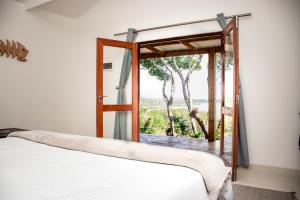 a room with a bed and a window with a view at The View @ Santa Maria in Santa Maria