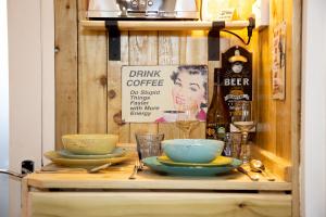 a table with bowls and glasses on top of it at The Baby Grand- Quirky & Compact in Torquay