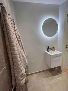 a bathroom with a sink and a mirror at KvarteretSkatan! in Ystad +10 photos
