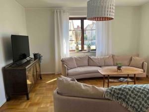 a living room with a couch and a table at KvarteretSkatan! in Ystad