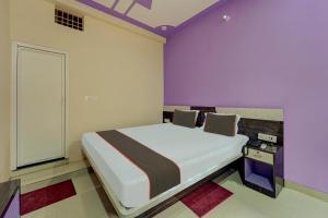 a bedroom with a large bed with purple walls at Collection O Siddhi Vinayak Hotel & Banquets in Motīhāri