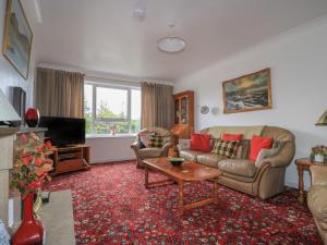 a living room with a couch and a tv at Dunard Villa in Stornoway