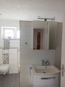 a white bathroom with a sink and a toilet at Bed and Bike Rheine in Rheine +56 photos
