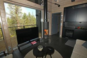 a living room with a fireplace in a house at Villa Kanger Ruka 2 in Kuusamo