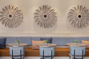 a row of tables in front of a bench with mirrors at Courtyard by Marriott Linz in Linz