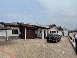 a car parked in front of a house at DND Apartments in Benin City
