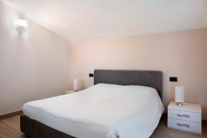 A bed or beds in a room at Nigella Langhe Home