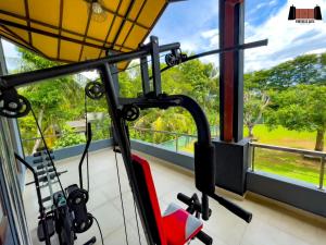 a gym room with a view of the garden at Fortress Gate Bungalow in Polonnaruwa