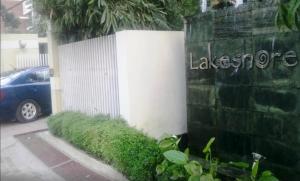 達卡的住宿－湖濱酒店&公寓，汽车旁挂有阿拉戈标志的墙