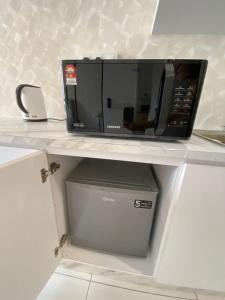 a microwave sitting on top of a shelf at Sky Trees Your Perfect Gateway with Pool & Facilities in Johor Bahru