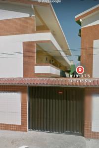 a building with a gate in front of it at Condomínio Enseada dos Corais apto completo in Cabo de Santo Agostinho