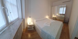 A bed or beds in a room at Appartamenti Reali Bonaccini