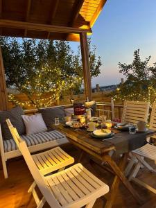 - une table et des chaises en bois sur une terrasse couverte avec une table et des chaises dans l'établissement Stylish Bungalow Villa In City, à Yakuplu