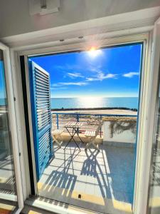 a view of the ocean from the balcony of a house at TRAMONTO Suite-Rome Airport FCO-Fronte mare in Fiumicino