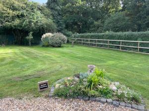 een tuin met een bord in het midden van een tuin bij Woodland House B & B in Wimborne Minster