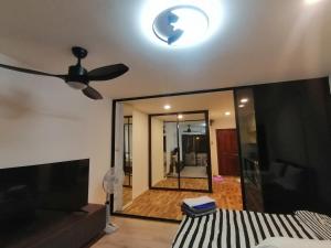 a bedroom with a ceiling fan and a mirror at Jomtien Hill Resort Pratamnak in Pattaya South