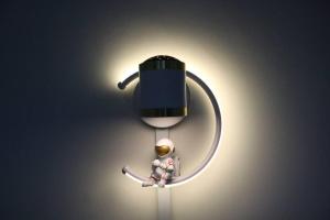 a light with a man sitting in a pot at Green Space Homestay Cozy Family(8-12pax) in Ipoh