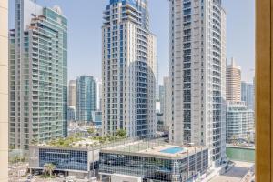 a view of two tall buildings in a city at GLOBALSTAY. Modern Apartments steps to JBR Beach in Dubai