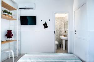 a bedroom with a door leading to a bathroom at P.C. Boutique H. Castel Nuovo, by ClaPa Group Dislocated Hospitality in Naples +192 photos