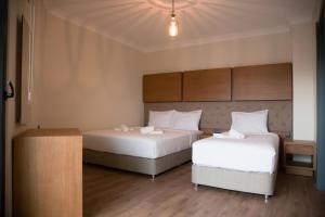 Postel nebo postele na pokoji v ubytování Ceneviz Suit Hotel