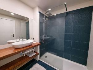 a bathroom with a sink and a shower and a tub at Olimpia Gardens View by Rentallido in São Gonçalo +25 photos