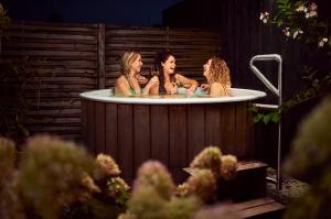 three women are sitting in a bath tub at Soof Heuvelrug in Rhenen