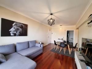 a living room with a couch and a table at Olimpia Gardens View by Rentallido in São Gonçalo