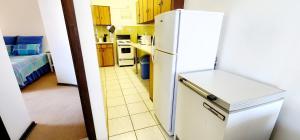 a kitchen with a white refrigerator in a room at Claridge Heights 305 – Sleeps 5 - Accross from Ramsgate’s main Blue Flag swimming beach in Margate