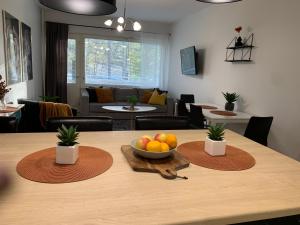 a dining room table with a bowl of fruit on it at 2BR Apartment, free parking - Peikontie in Oulu