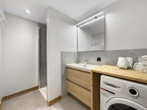 - une buanderie avec un évier et un lave-linge dans l'établissement GRD005 - Appartement standing 6 pers pied de piste, aux Carroz d'Arâches
