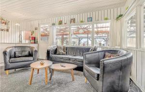 a living room with two leather chairs and a table at Nice Home In Sydals With Wifi in Østerby