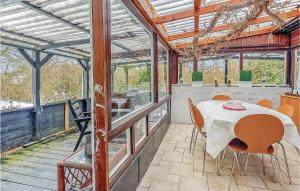 a conservatory with a table and chairs on a patio at Nice Home In Sydals With Wifi in Østerby