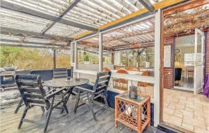 a patio with a table and chairs on a deck at Nice Home In Sydals With Wifi in Østerby