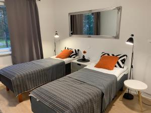 a bedroom with two beds and a window at 2BR Apartment, free parking - Peikontie in Oulu