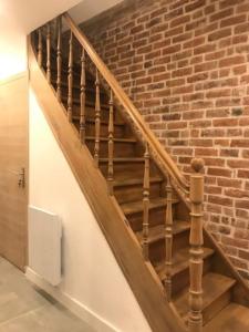 a staircase with a brick wall and a stair case at L havre de paix in Avelin